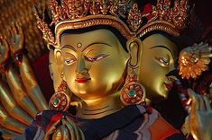 there are two golden buddha statues next to each other