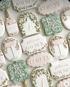 decorated cookies with the names and date for each wedding day are displayed on a table