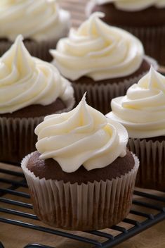 there are some chocolate cupcakes with white frosting on top and the words vodka cupcakes above them