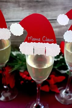 three wine glasses with santa hats on them