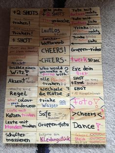 a bunch of wooden signs with words written on them sitting on the floor in front of a carpeted area