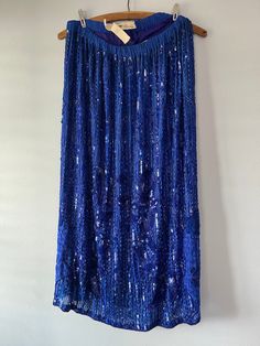 Gorgeous vintage formal skirt. Sequin and beaded. Silk. Lined. Royal blue. Tag size small. Fits small to medium. Cotton Candy label. Made in India.  Arm pit to arm pit = 14 to 16 Hips= 19.5 Length = 32 Condition = waist seems a little stretched out or the elastic is stretched.  May be a bead missing here or there. Vintage Baby Boys, Vintage Christmas Sweaters, Blue Maxi Skirt, Beaded Skirt, Formal Skirt, Vintage Rock, Embroidered Skirt, Blue Maxi, Sequin Beading