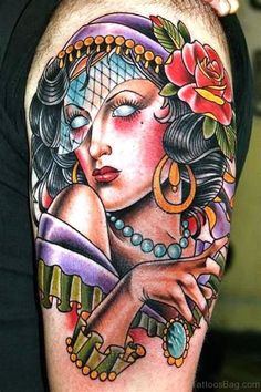 a woman's arm with tattoos on it and a rose in the middle of her arm