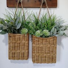 two wicker baskets with plants hanging from the wall