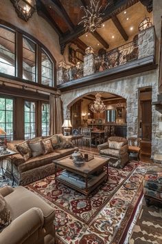 a large living room filled with furniture and lots of windows on top of the ceiling