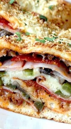 a close up of a sandwich on a plate with cheese and vegetables in the middle