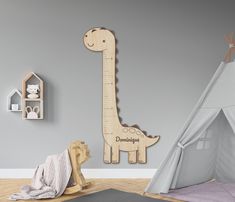 a child's room with a giraffe wall decal and teepee tent