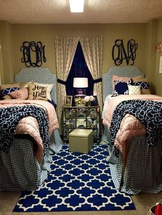 two twin beds in a room with blue and white decor on the walls, along with matching bedding