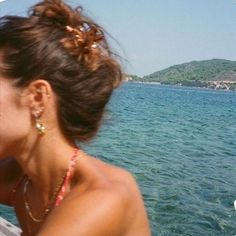 a woman sitting on a boat looking out at the water