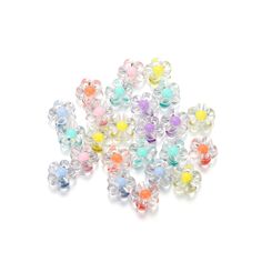 many different colored beads on a white surface