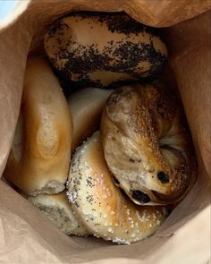 bagels and other pastries in a brown paper bag