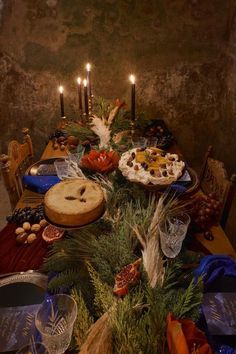 a table topped with lots of food and candles