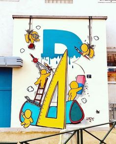 a large mural on the side of a building with cartoon characters and letters painted on it