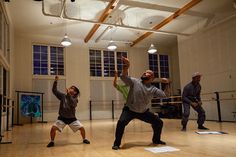 three men in a dance studio practicing their moves