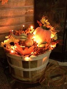 a basket filled with pumpkins and candles