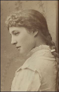 an old photo of a woman with braids on her hair and wearing a blouse