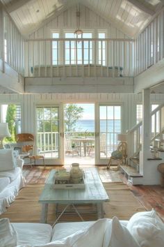 a living room filled with furniture and lots of windows