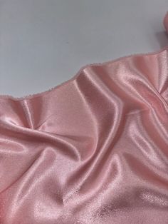 the fabric is shiny and pink in color