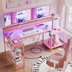 a pink desk with two monitors and a keyboard