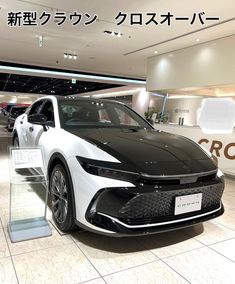 a white car is on display in a showroom