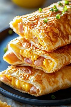 three crepes stacked on top of each other with meat and cheese in the middle