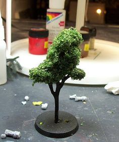 a small green tree sitting on top of a table