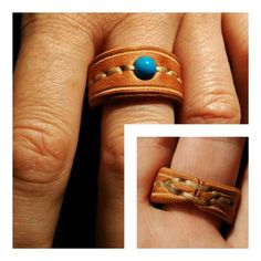 a woman's hand with two rings on it and a blue stone in the middle