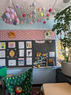 an office with lots of decorations hanging from the ceiling and desks in front of it