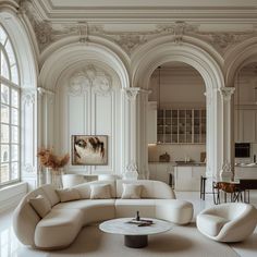 an elegant living room with white furniture and large arched windows in the ceiling, along with marble flooring