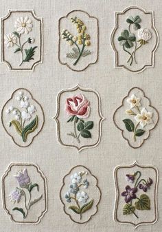 nine embroidered flowers are displayed in small frames