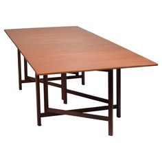 a wooden table with two legs and a square shaped top on an isolated white background