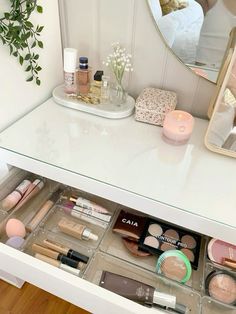 an open drawer with makeup and cosmetics on it