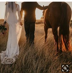 a bride and groom walk their horse through the tall grass at sunset in an open field