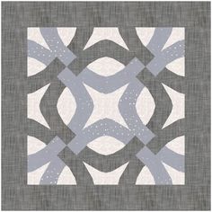 a gray and white quilt with an abstract design