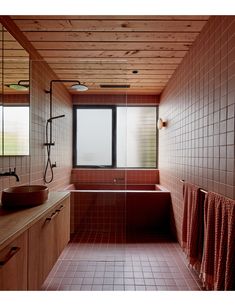 a bath room with a sink and a bath tub next to a window in it