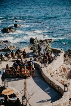 A beautiful beachside wedding set-up at the Esperanza resort in Cabo San Lucas, with blue ocean waves and palm trees in the background. The decor features colorful floral arrangements, elegant table settings, and romantic string lights creating a magical ambiance. #love #wedding #weddingplanner #weddingplanning #destinationwedding #mexico #loscabos #luxury #luxurywedding Beach Castle Wedding, Wedding By The Ocean, Greece Beach Wedding, Beach Resort Wedding, Destination Wedding Ceremony, Beachfront Wedding, Wedding By The Sea