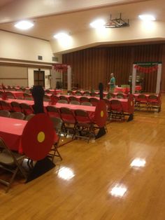 an empty room with tables and chairs set up for a banquet or party, ready to be served