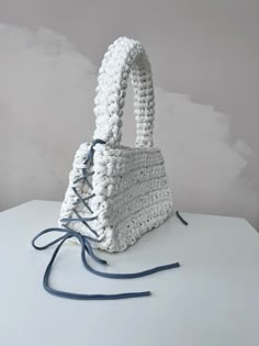 a white purse sitting on top of a table