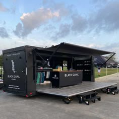 a black trailer with surfboards in the back