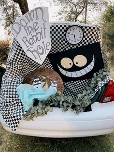 a car decorated with plates and decorations for the drive - in movie, down the rabbit hole