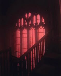 the light is shining through two windows in an old building with stairs leading up to it