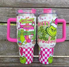 two tumblers sitting on top of a wooden bench with pink handles and the words merry grin