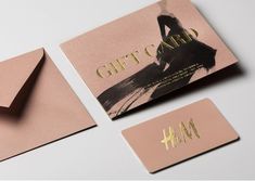 two business cards with gold foil on them and one has a woman's silhouette