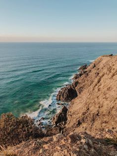 an ocean view from the top of a hill