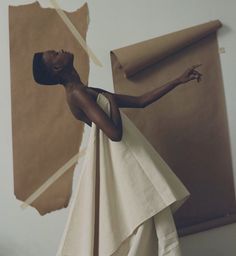 a woman standing in front of a piece of artwork