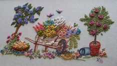 an embroidered piece with flowers and plants on it