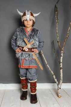 a little boy dressed up as a viking