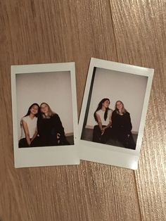 two polaroids sitting next to each other on top of a wooden table together