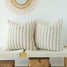 two pillows sitting on top of a wooden bench