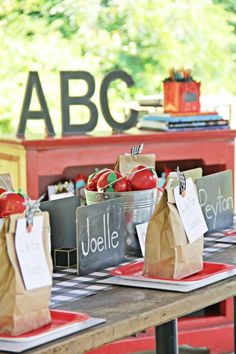 some paper bags with apples in them sitting on a table